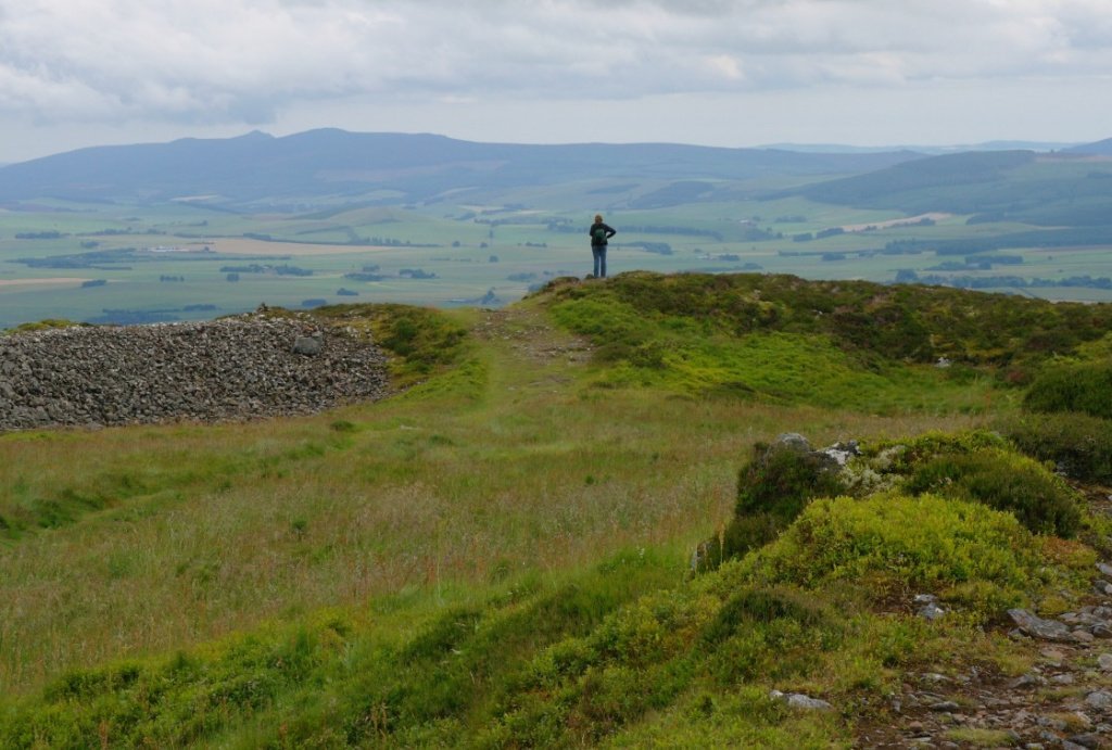 This is the summit 'platform' of the Tap o Noth, looking east-ish towards the rich farmlands of the Garioch (pronounced 'geer-ee), with the top of the landmark hill of Bennachie towards the left horizon.