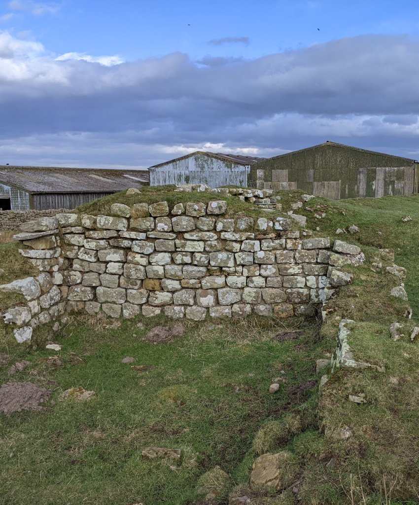 (Pictured) A small part of Aesica Roman Fort on The Wall at Great Chesters and much less visited/interpreted than the more famous Housesteads Fort to the east. 

Note how past and present overlap. The northern part of the fort is covered in farm buildings, much of the fort is in a grazing field.